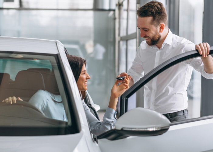 Car in showroom, salesperson