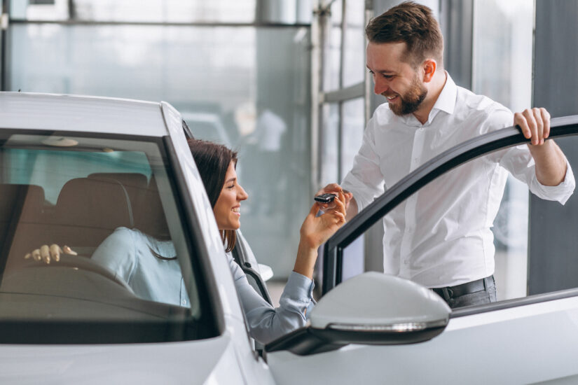 Car in showroom, salesperson