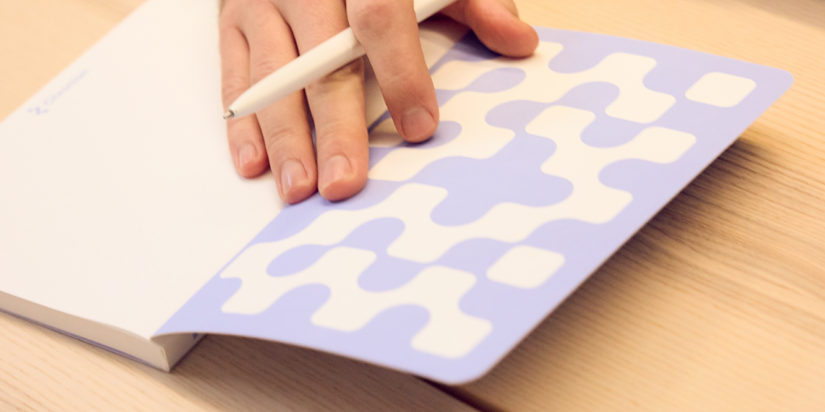 Chronion employee writing in the Chronion notebook