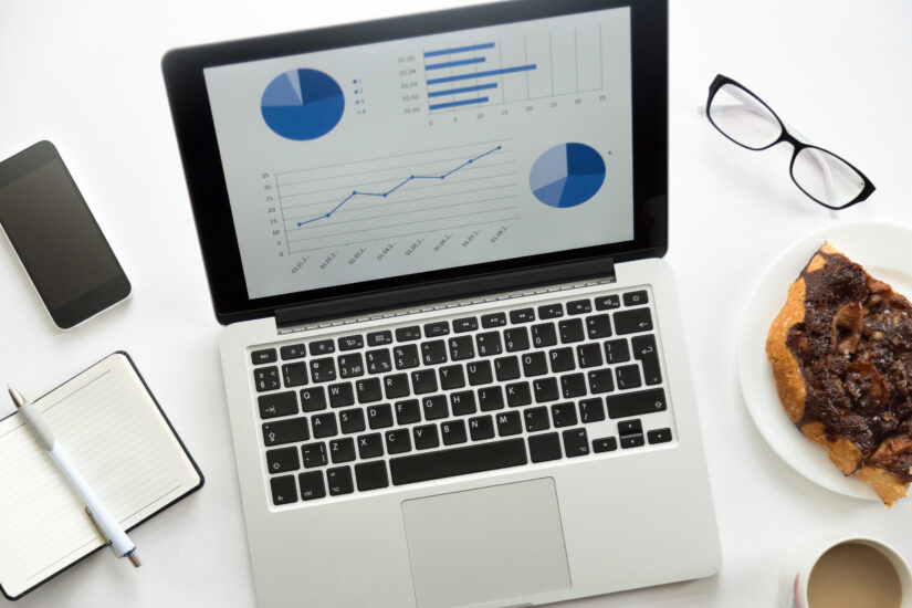 Open laptop with diagram glasses mobile office supplies