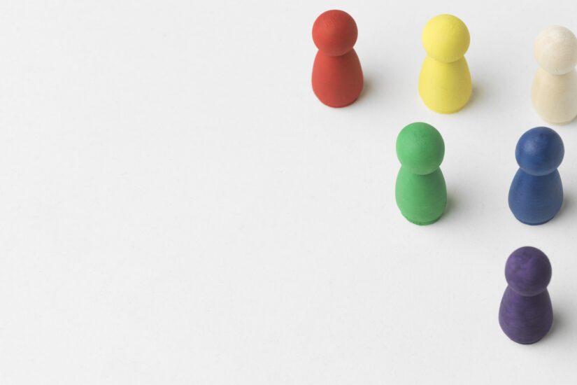 Colorful pawns white background with copy space